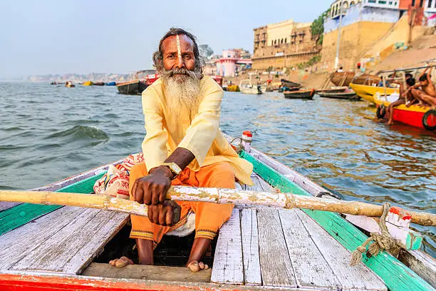 Photo of Sadhu rowing boat on the holy Ganges River in Varanasi