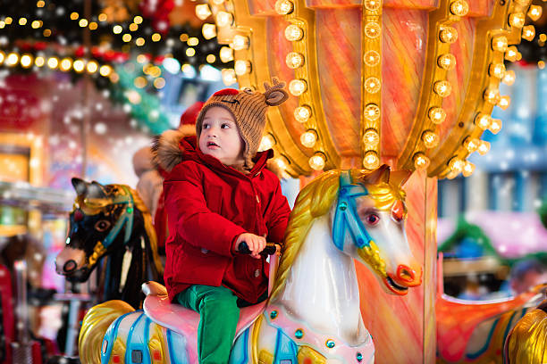 istock Child riding carousel on Christmas market 622788728