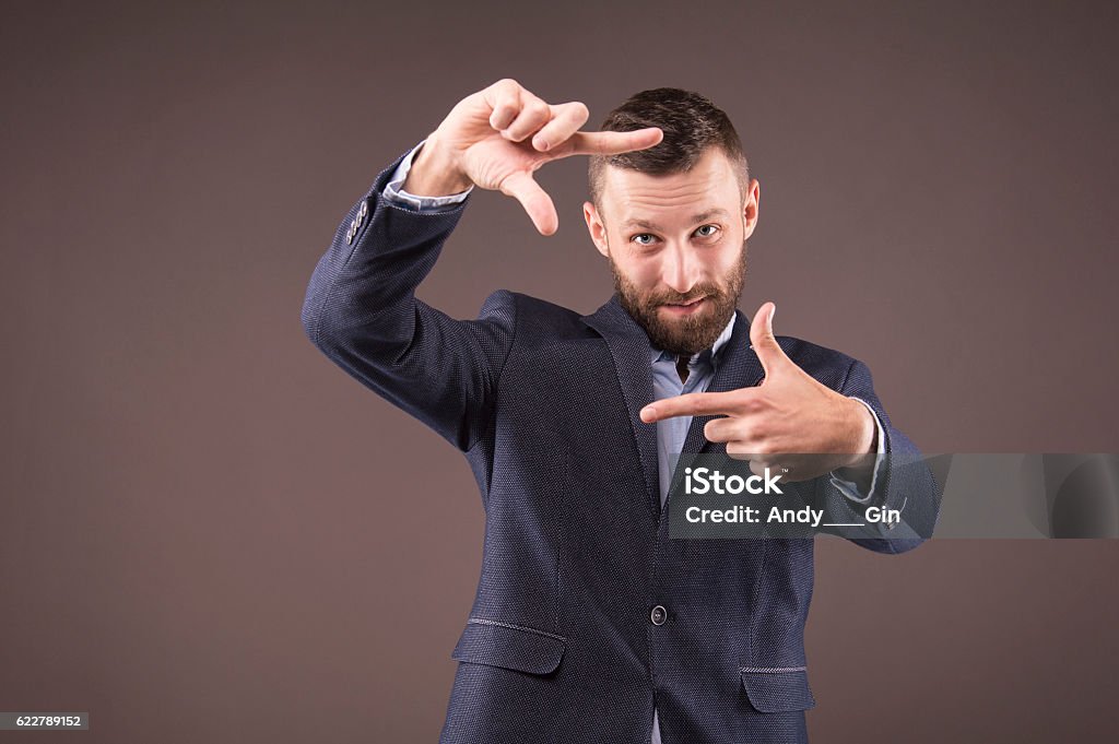 Business man looking at the camera Business man looking at the camera through the frame Active Seniors Stock Photo