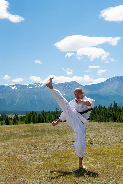 istock Man in white kimono and black belt training karate on 622789422