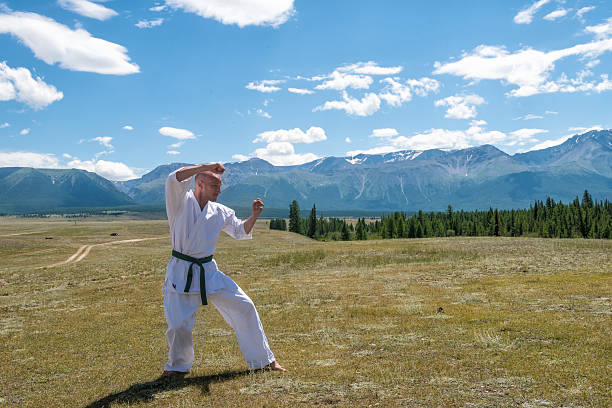istock Man in white kimono and black belt training karate on 622789750
