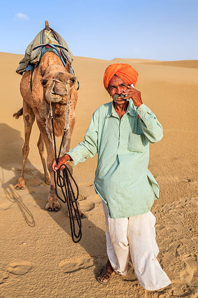 istock Indian man using a mobile, desert village, India 622791296
