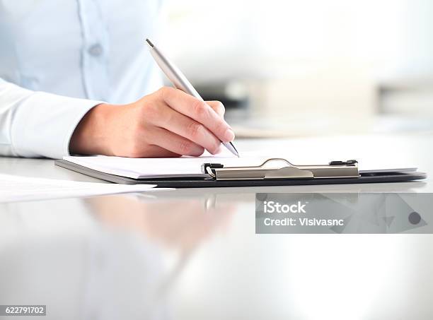 Woman Hands Writing On Clipboard With A Pen Stock Photo - Download Image Now - Clipboard, Writing - Activity, Handwriting