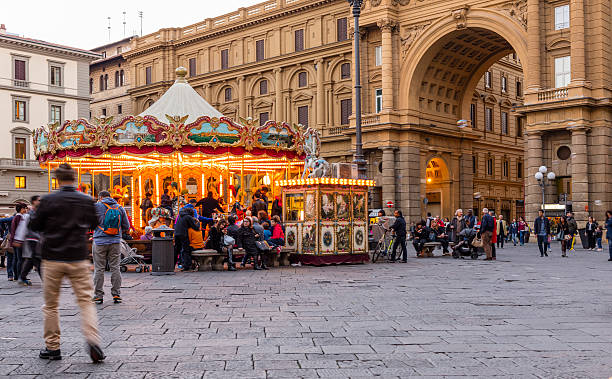 Florence, Italy - October 31, 2016: Piazza della Repubblica (Republic Square) in the evening,  with a carousel, tourists, and pedestrians. Piazza della Repubblica is on the site of the ancient Roman Forum.