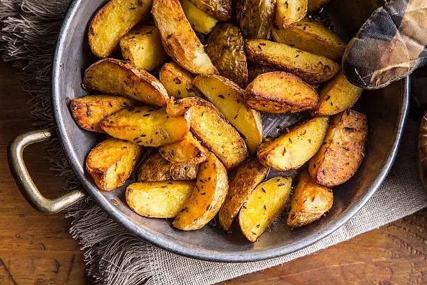 Photo of Potato. Roasted potatoes. American potatoes with salt pepper and cumin.