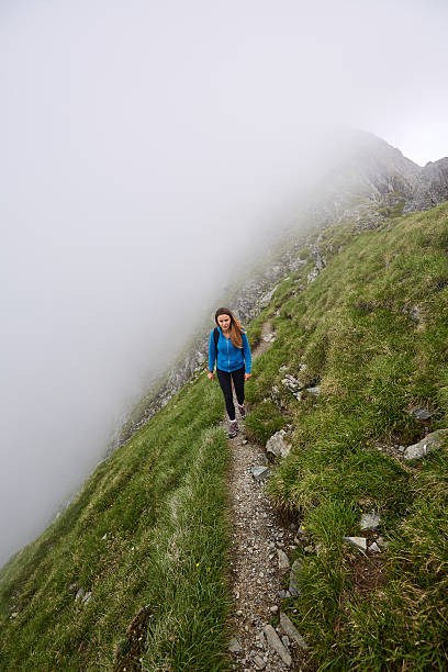 istock Woman backpacker hiking on a trail 622798094