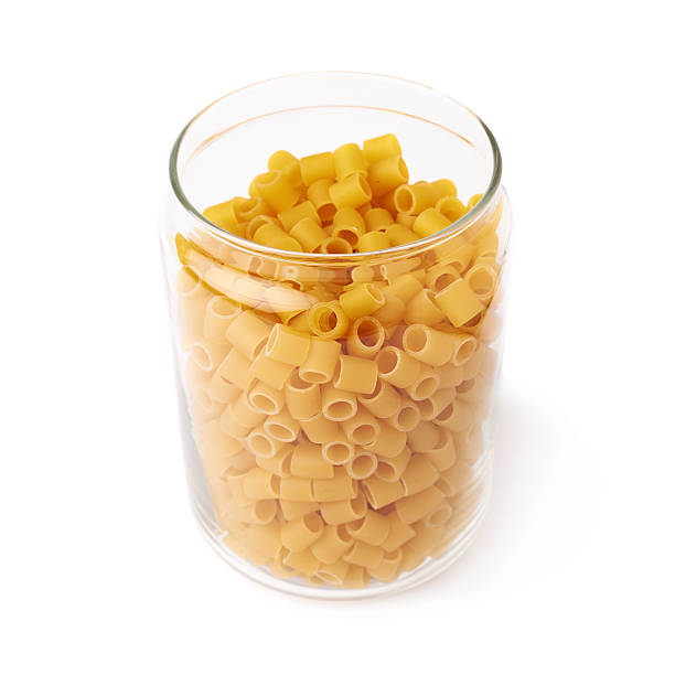 istock Glass jar filled with dry ditalini pasta over isolated white 622798326