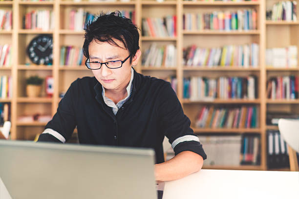 istock Asian man working on laptop with serious face 622800116