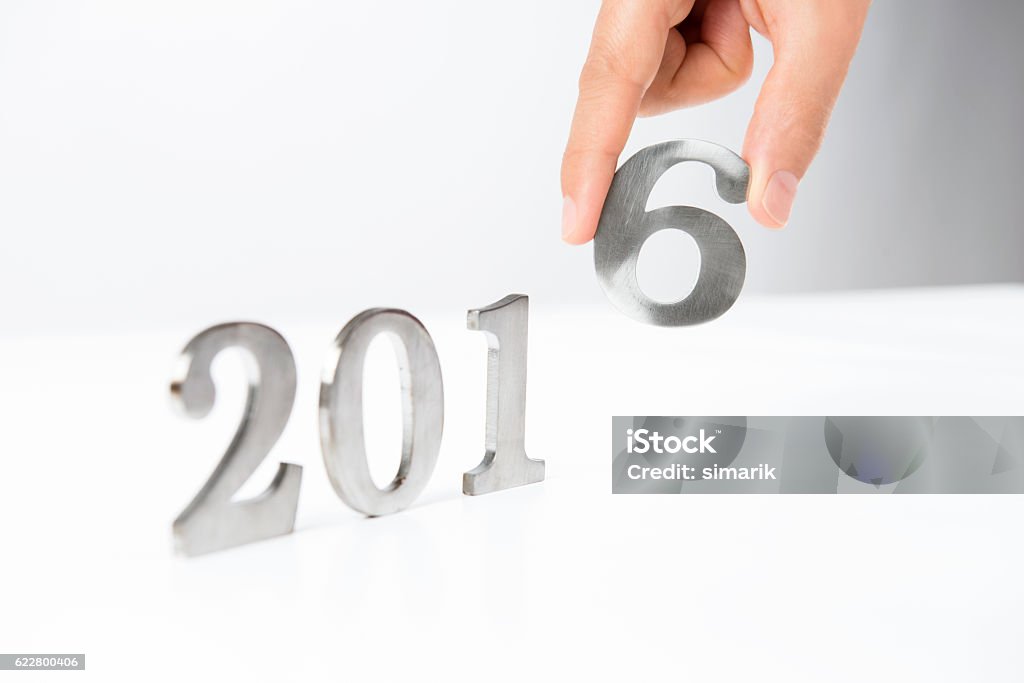 Year 2016 Caucasian female is completing last digit of number 2016 with 6 in hand. 2016 Stock Photo