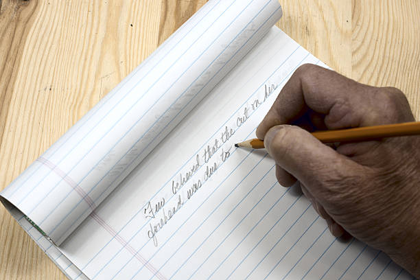 istock An author beginning his manuscript with pencil and pad 622800920