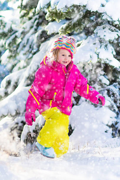 istock Child in colorful jacket having fun in snowy winter park 622800992