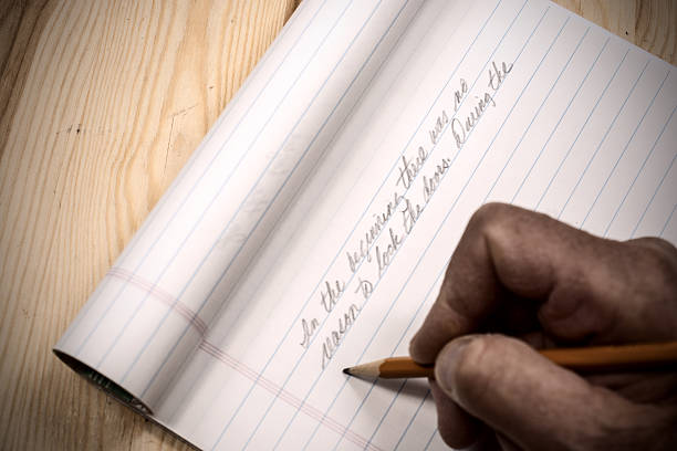 istock An author beginning his manuscript with pencil and pad 622801256