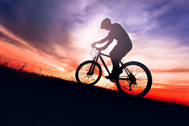 istock Silhouette of biker on mud trail with sky background, sunset 622802320