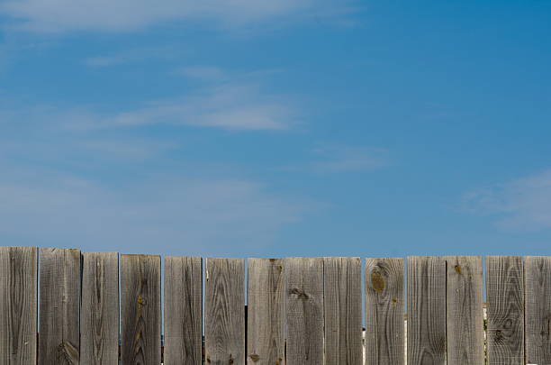 istock old wooden fence with gate on sky background 622804288