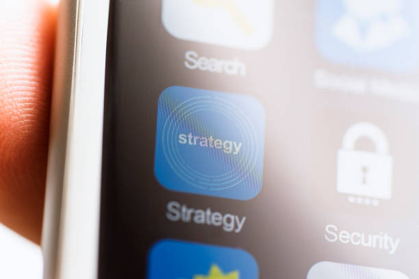 istock Hand holding phone, strategy app on phone screen 622804390