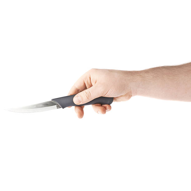 istock Hand holding a knife, composition isolated over the white background 622807508