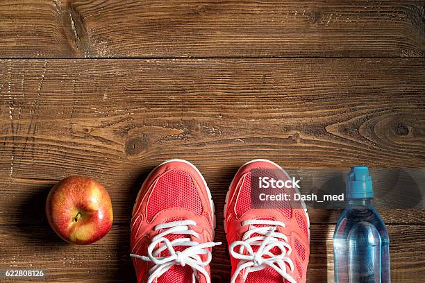 Fitness Concept Pink Sneakers Red Apple And Bottle Of Water Stock Photo - Download Image Now