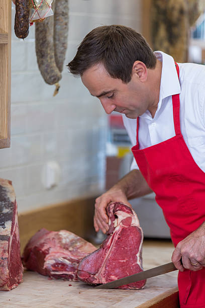 istock Butcher Preparing Meat In Shop 622808896