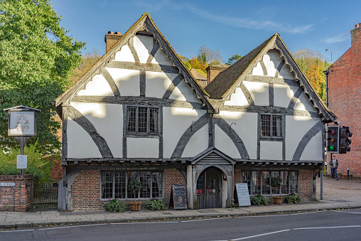 Winchester, United Kingdom - November 13, 2016: The Chesil Rectory. The oldest restaurant in the City of Winchester. A person is walking in the adjacent street towards the road.