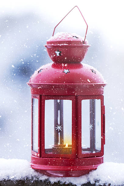 istock Christmas candle lantern on a snowy background outside 622810302