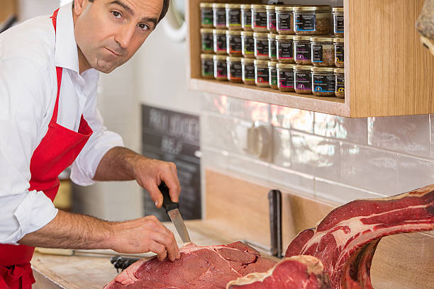 istock Butcher Preparing Meat In Shop 622811058