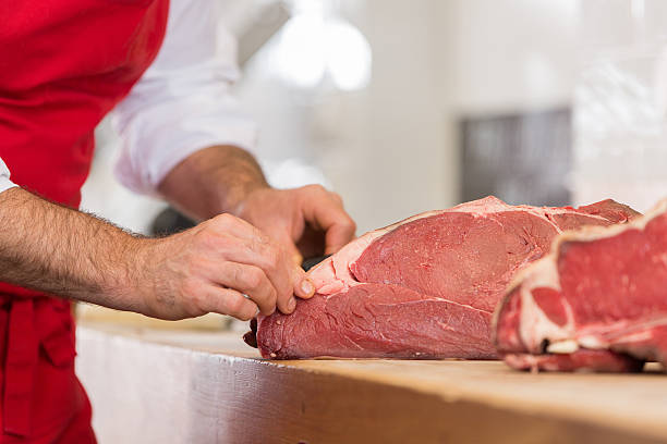 istock Butcher Preparing Meat In Shop 622811222