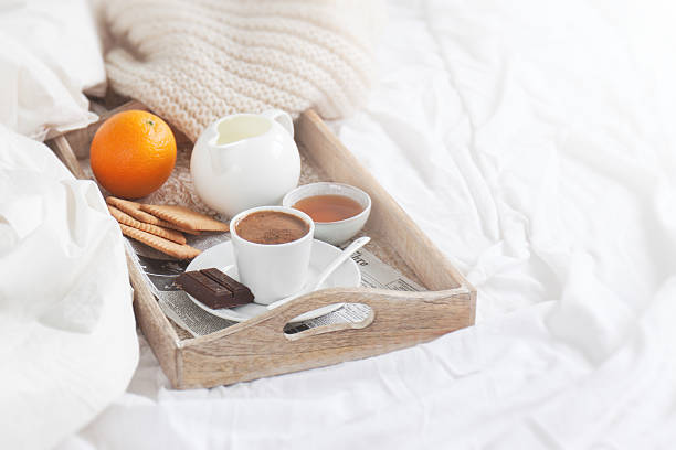 istock Romantic breakfast on bed with coffee, cookies, orange and choco 622888106