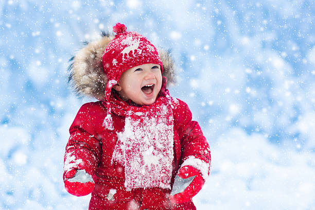 istock Little baby playing with snow in winter. 622894882
