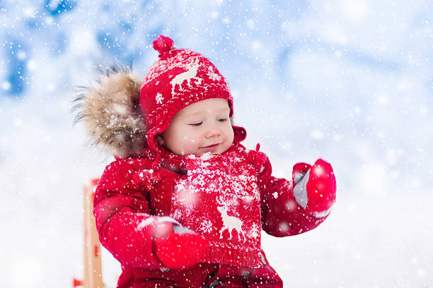 istock Kids play in snow in mountains. Winter sleigh ride 622896268