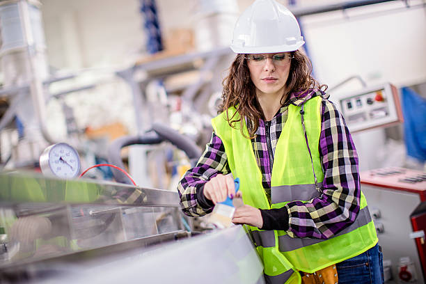 istock Young woman doing precise work in a factory 622897484