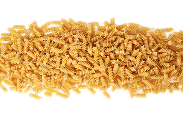 istock Line made of dry rotini pasta over isolated white background 622899636