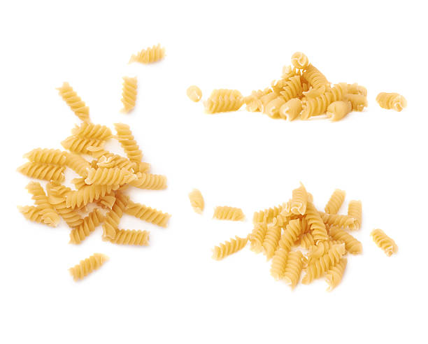istock Pile of dry pasta rotini over isolated white background 622900580