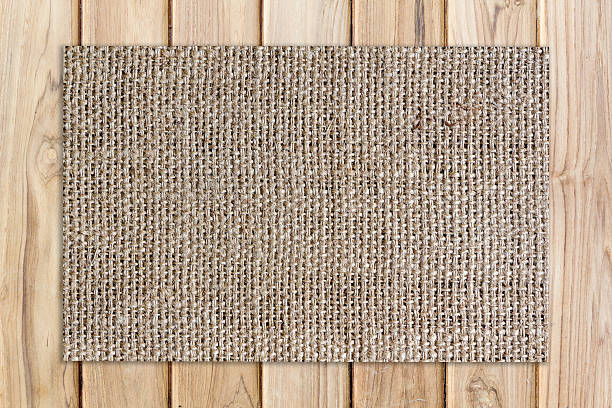 istock burlap mat on plank wooden texture and background 622901274