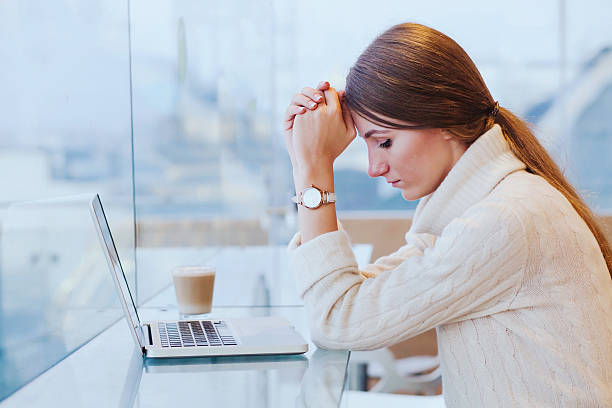 stress, sad tired woman near computer information overload, stress concept, sad desperate woman in front of computer information overload photos stock pictures, royalty-free photos & images