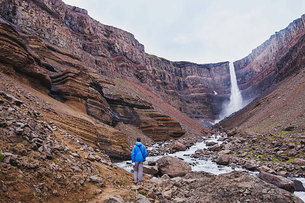 istock hiker walking to Hengifoss waterfall in Iceland 622901940
