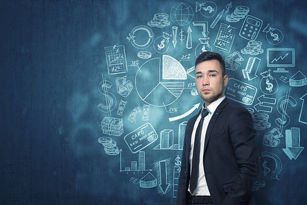 istock Young businessman standing in front of dark blue wall with 622902934