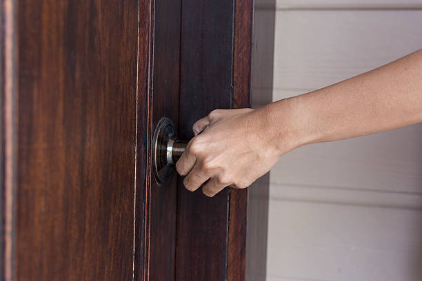 istock hand hold handle of wood door 622906972