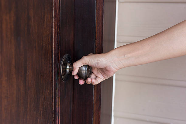 istock hand hold handle of wood door 622907820
