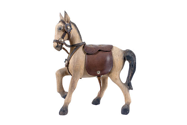 istock Old wooden horse with leather saddle isolated on white 622908536