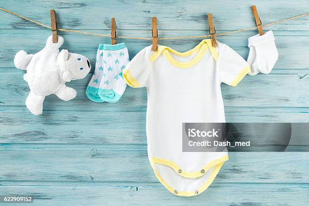 Baby Clothes Onesie Socks White Bear Toy On A Clothesline Stock Photo - Download Image Now