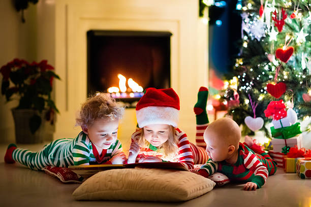 istock Happy little kids in pajamas under Christmas tree 622910550