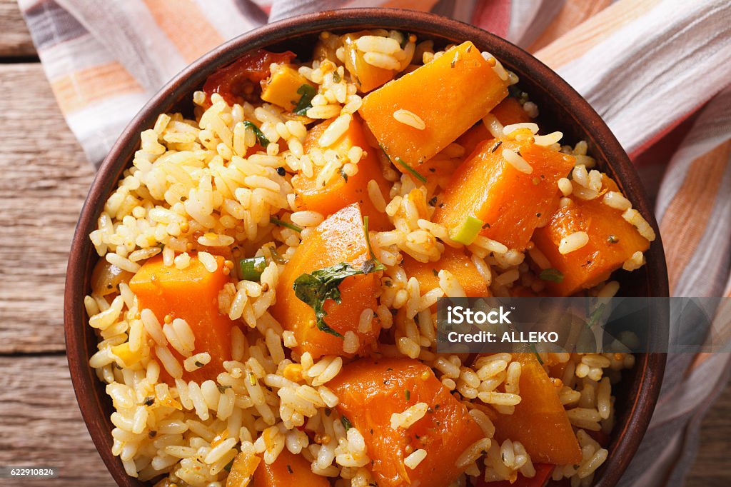 Risotto with pumpkin in a bowl close-up. Horizontal top view Risotto with pumpkin in a bowl close-up on the table. Horizontal top view Above Stock Photo