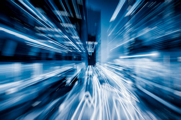 Blurred skyscrapers by night with bokeh lights trail using zoom technique