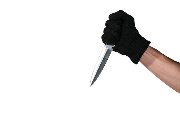 istock Hand with black glove holding a dagger. Isolated. 622912026