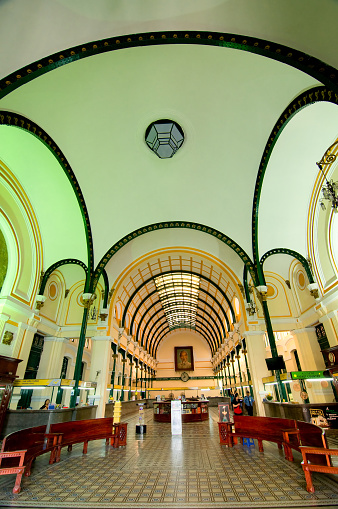 Ho Chi Minh, Vietnam - March 8, 2015: Saigon Central Post Office is a post office in the downtown Ho Chi Minh City, near Saigon Notre-Dame Basilica, the city's cathedral. The building was constructed when Vietnam was part of French Indochina in the late 19th century. It counts with Gothic, Renaissance and French influences. It was constructed between 1886-1891 and is now a tourist attraction.