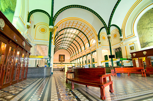 Ho Chi Minh, Vietnam - March 8, 2015: Saigon Central Post Office is a post office in the downtown Ho Chi Minh City, near Saigon Notre-Dame Basilica, the city's cathedral. The building was constructed when Vietnam was part of French Indochina in the late 19th century. It counts with Gothic, Renaissance and French influences. It was constructed between 1886-1891 and is now a tourist attraction.