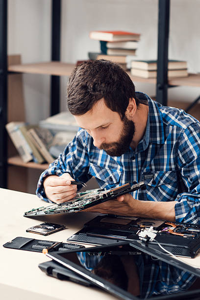 istock Bearded repairman disassemble computer motherboard 622912424