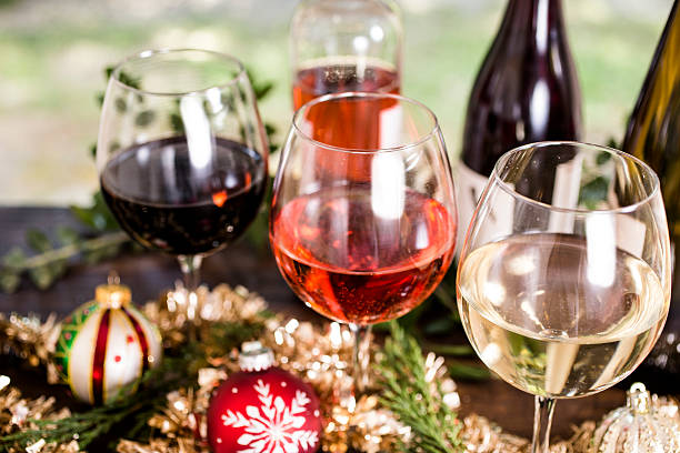 Various wines in glasses on dining table at Christmas.