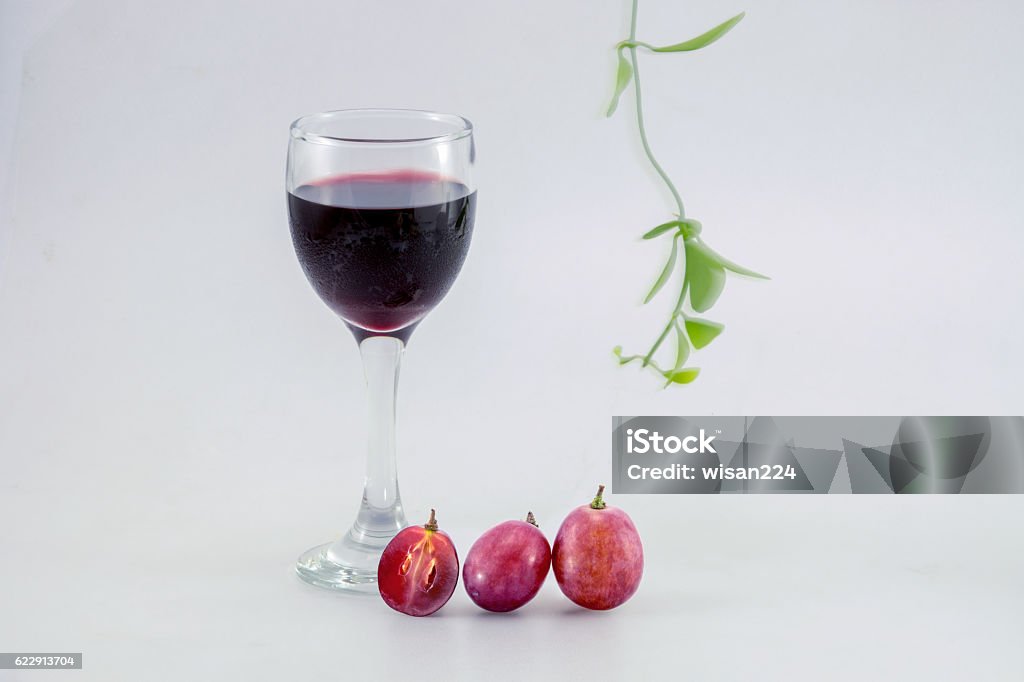 glass of wine and grapes, isolated on white Agriculture Stock Photo