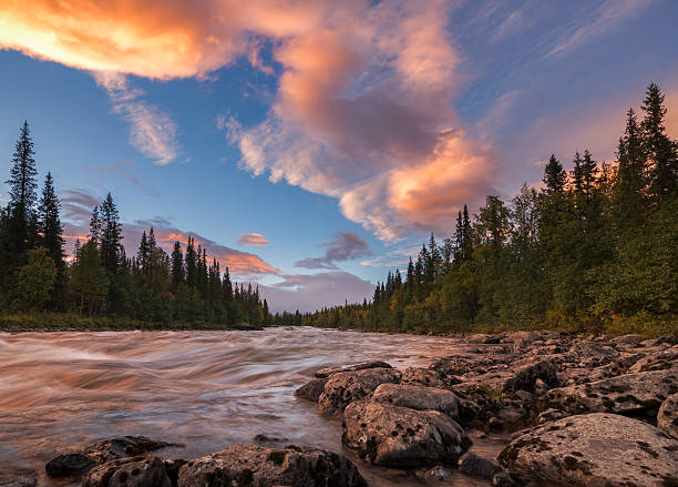istock Tranquil and calm river sunset with beautiful orange clouds, Sweden 622913914